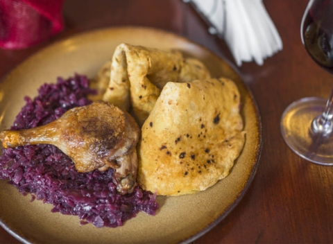 Chrumkavé pečené kačacie stehno alebo prsia s kapustou, lokšami a pohárom vína.